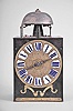 Jean Baptiste Baud, Bellefontaine, France, Comtoise clock, 8 day, time and strike with alarm, weight driven movement with verge escapement, thread suspension with rear-hanging pendulum in a iron post and plate frame, cast brass dial with birds, valances, and inset enamel cartouche numerals, brass alarm ring with Arabic numerals, single pierced iron hand, pivoted brass winding arbor shutters, and lower brass plaque signed "JEAN BAPTISTE BAUD A BELLE FONTAINE ".