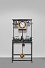 Europe, tower clock, time, strike and chime, three train movement with pinwheel escapement in a green painted cast iron frame with decorative pendulum bob now arranged in a custom stand and frame with bells and dial to operate in a standard room. Nameplate attached to frame is engraved "PAUL GARNIER Horloger Mecanicien 6&17 Rue Taitbour Paris ".