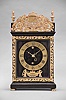 Thuret, a Paris, a 17th century pendule religieuse, the ebonized hardwood case with molded base and cornice, the door with cast, gilt trim, and top finials and cast foliate ornament, with what appears to be a family crest at center, case sides with astragal ended apertures with sliding shutters removable from the top, deep blue velvet lined wooden dial plate, gilt roman numeral dial with Arabic minutes, and gilt mount with laurel and trailing ribbon ornamented cartouche engraved "J. Thuret A Paris", 30 hour two train movement with baluster pillars, powered by a single barrel, and counting the hours on a bell, crown wheel escapement and copper strip suspension with cycloidal cheeks, and decorative, pierced steel levers for strike train warning and locking, and pendulum with turned brass bob