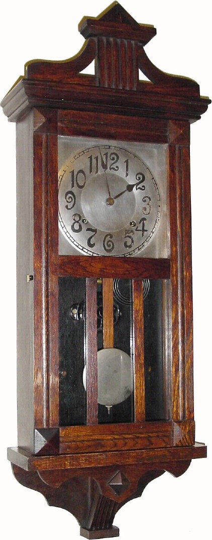 C.1925, William L. Gilbert Clock Co., No. 3040, "Limerick" 8-day time/strike oak wall clock. — Antique Clocks Price Guide