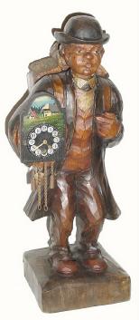 C.1925, German, Carved Wood mechanical whistler, clock peddler, with working clock in his arms, and a load of clocks on his back. — Antique Clocks Price Guide