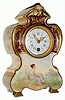 C.1900, French porcelain timepiece with extremely handsome case with raised gilt decoration and painting of seated woman on front, the case sides with geometric gold decorations.