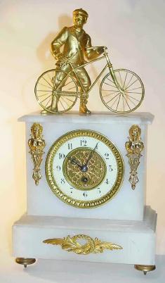 C.1900, French, Man and His Bicycle, atop a white alabaster case, — Antique Clocks Price Guide