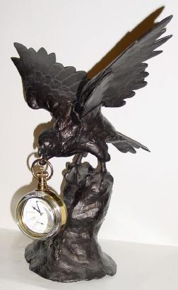 Mixed lot: C.1900, cast white metal American Eagle clock holder, now with a C.1990, foreign paperweight clock, not running. — Antique Clocks Price Guide