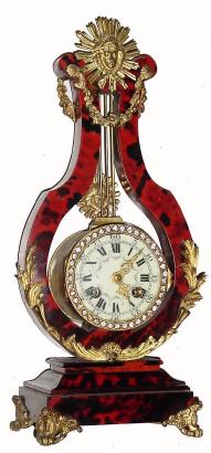 C.1890, French, Small Lyre clock, the case veneered with red tortoise shell, and with ormolu mounts. — Antique Clocks Price Guide