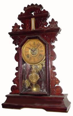 C.1885, E. Ingraham & Co., 8-day time/strike/alarm gingerbread clock in pretty good condition with a heavy coat of the varnish over the original finish. — Antique Clocks Price Guide