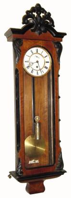 C.1890, German, 1-Weight "Vienna Regulator" in generally good condition, the case refinished and two of the "leafy" elements on the door crudely carved, and finials missing. — Antique Clocks Price Guide
