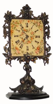 C.1900, German, night clock timepiece, 30-hour, in very nice condition with an original bronze finished iron frame & stand. — Antique Clocks Price Guide