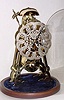 Mid 20th Century, English, Passing Strike Skeleton clock in a rafter style frame with engraving on the front plate.