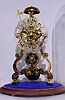 Mid 20th Century, English, Passing Strike Skeleton clock in a scroll style frame with profuse engraving on the front plate. 