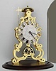 Mid 20th Century, English, Passing Strike Skeleton clock in a large scroll frame with profuse engraving on the front plate. 