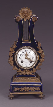 A LOUIS XVI STYLE ORMOLU-MOUNTED AND 'JEWELED' BLUE-GROUND PORCELAIN LYRE CLOCK, Late 19th/early 20th century, retailed by Blair & Crawford. — Antique Clocks Price Guide
