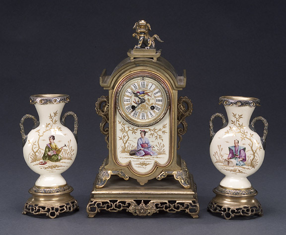 AN AESTHETIC MOVEMENT POLYCHROME-GILT BRONZE MOUNTED ENGLISH POTTERY CLOCK GARNITURE, Late 19th century, retailer's mark for J.E. Caldwell & Co., Philadelphia, no. 10793. — Antique Clocks Price Guide