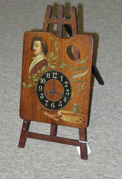 A PAINTED WOOD EASEL-FORM TABLE CLOCK, early 20th century. — Antique Clocks Price Guide