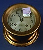 A BRASS CASED SHIPS BELL CLOCK Labeled Chelsea, England.