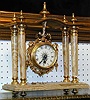 A LOUIS XVI STYLE GILT BRONZE MOUNTED ONYX MANTEL CLOCK.