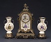 AN AESTHETIC MOVEMENT POLYCHROME-GILT BRONZE MOUNTED ENGLISH POTTERY CLOCK GARNITURE, Late 19th century, retailer's mark for J.E. Caldwell & Co., Philadelphia, no. 10793.