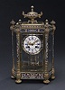 A FRENCH GILT BRONZE AND CHAMPLEVE MANTEL CLOCK, late 19th/early 20th century..