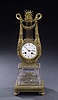 A FRENCH EMPIRE STYLE GILT BRONZE AND GLASS MANTEL CLOCK, late 19th century.