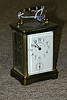 A FRENCH BRASS AND GLASS CARRIAGE CLOCK, the works stamped Duverdrey & Bloquel, retailed by Memod, Jacquard & King, St. Louis.