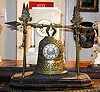 A GILT-METAL SANTUS BELL CLOCK, Late 19th/early 20th century.