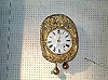 A FRENCH MOLDED BRASS WALL CLOCK, 19th century.