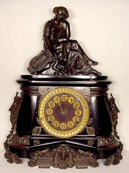 Ansonia black metal with ornate brass trim — Antique Clocks Price Guide