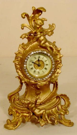 Ansonia metal cherub figural clock — Antique Clocks Price Guide