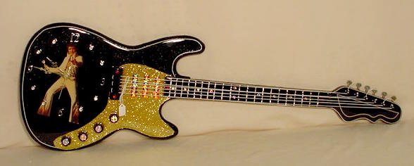 Battery operated Elvis guitar clock: — Antique Clocks Price Guide