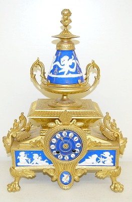 French Dore and Porcelain Cherub Decorated Clock — Antique Clocks Price Guide