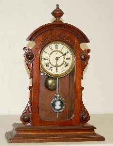 Waterbury Walnut Parlor Clock w/ Lady Pendulum — Antique Clocks Price Guide